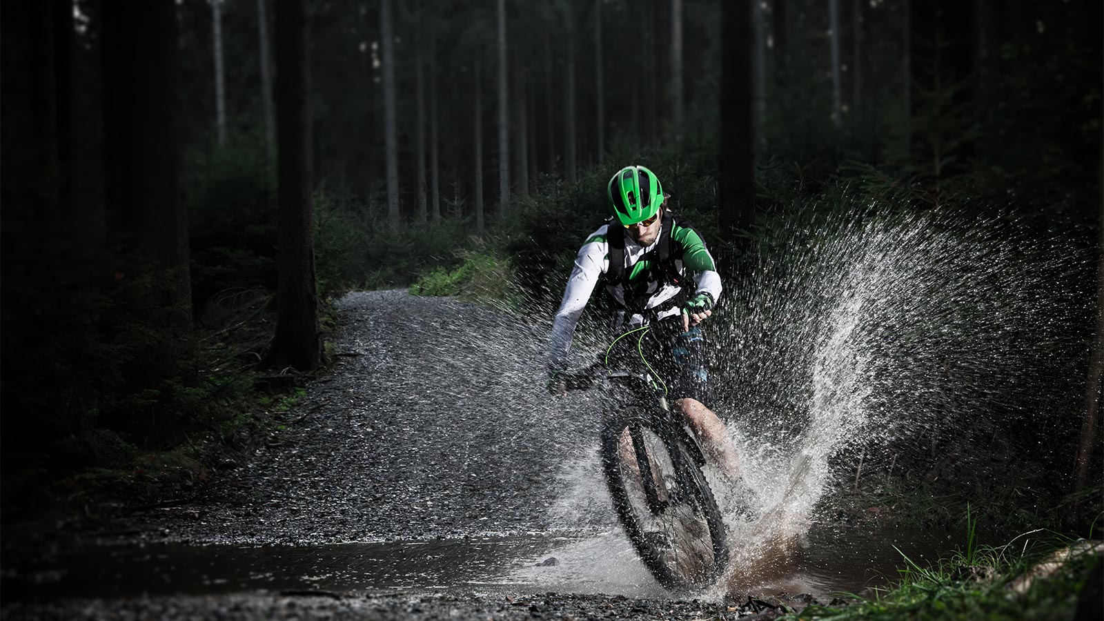 A cyclist passes over a stream with his mtb